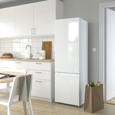 Modern kitchen with large LAGAN fridge/freezer and wooden countertop.
