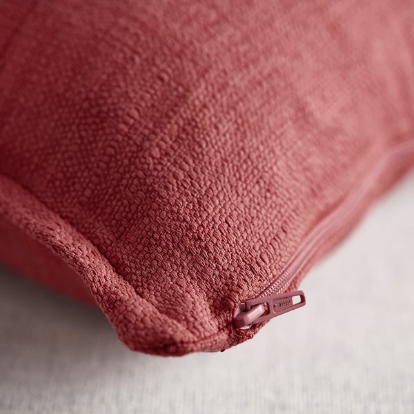 Pink-red cushion cover with zip, textured matte finish.