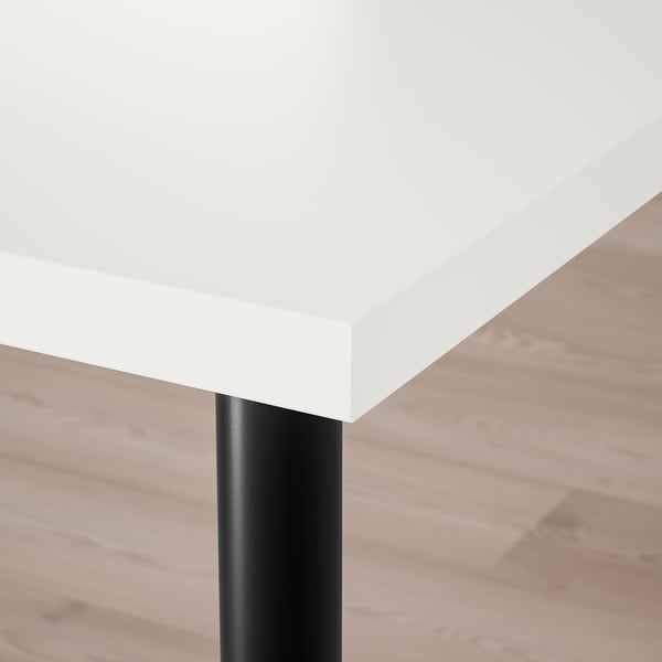 White tabletop with black metal leg; clean, modern design.