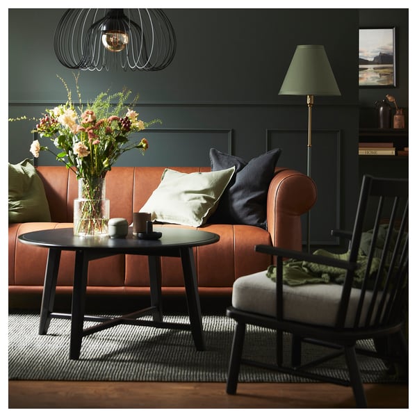 Dark green LANDBANA rug with natural jute material, rectangular shape, and rustic design in a modern living space.