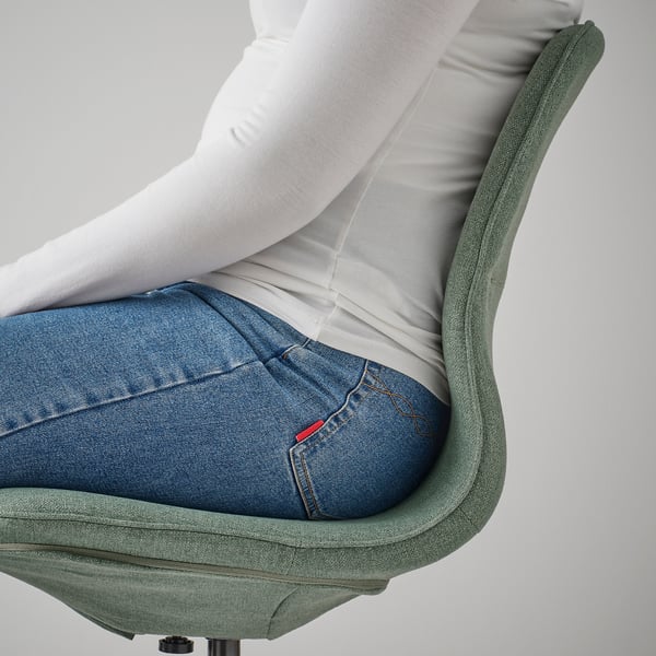 Person sitting in LÅNGFJÄLL office chair, showing height-adjustable seat and lumbar support.