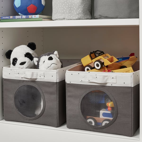 Two fabric storage bins on a shelf, one containing stuffed pandas and the other filled with childrens toys, featuring mesh windows to view contents.