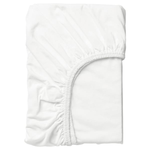 Fitted white cotton sheet, smooth, all-around elastic, neatly folded.