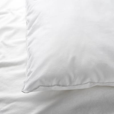 Close-up of a soft, white pillowcase in pristine condition, showing smooth fabric and precise stitching.