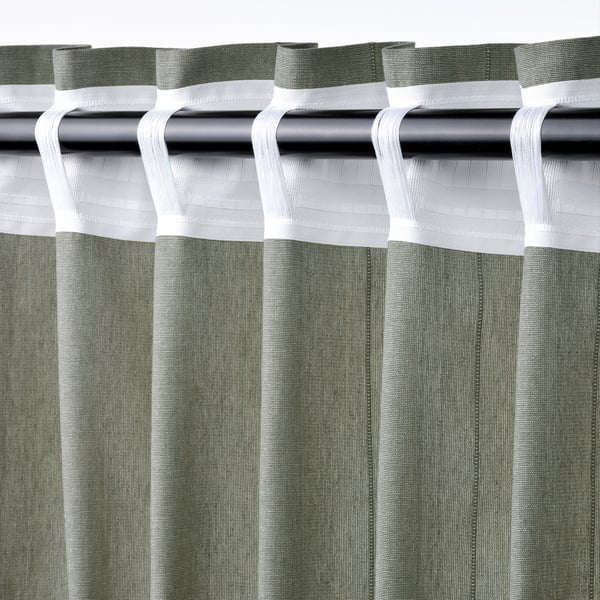 Green curtains with white tabs, slide for privacy and light.