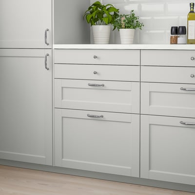 White LERHYTTAN kitchen cabinet drawers, light grey finish, solid birch with bevelled edges, smaller herbs on top.