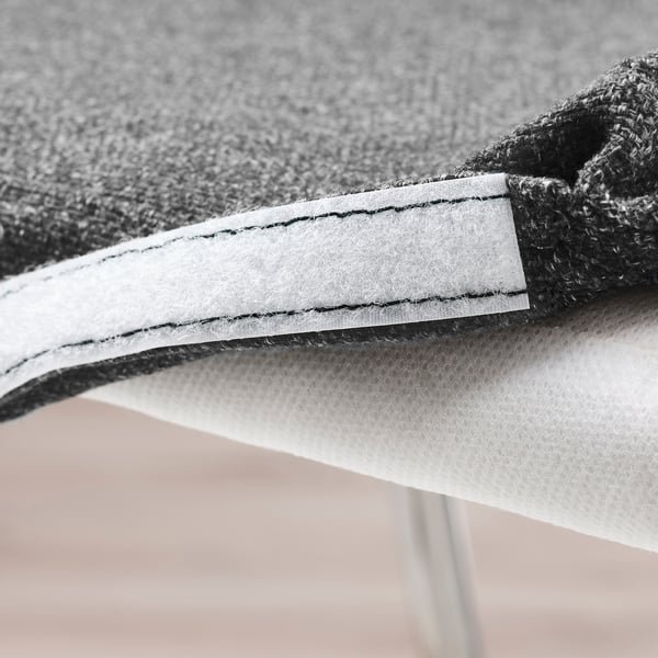 Close-up of LILLÅNÄS bar stool detail: white stitching on grey fabric, foam cushioning, and knit backrest, highlighting comfort and durability.