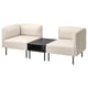 Two light beige armchairs with a matching coffee table, modern design, fabric upholstery, metal legs.