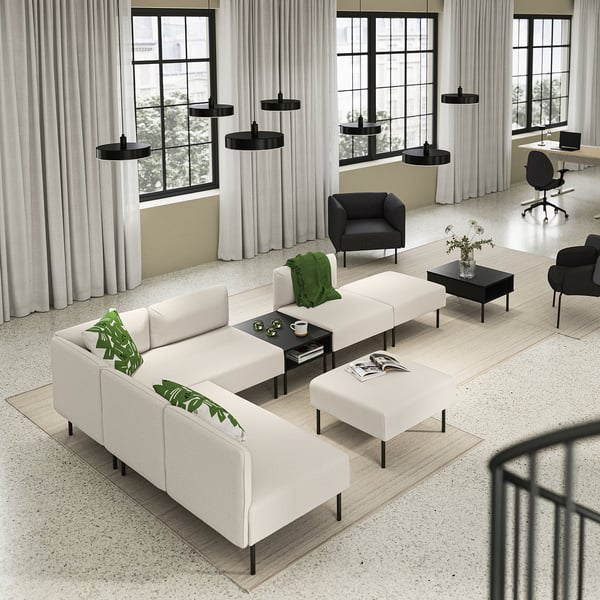 Modern, minimalist living area with white LILLEHEM sofa, black accents, wooden floor, large windows, and hanging lamps.