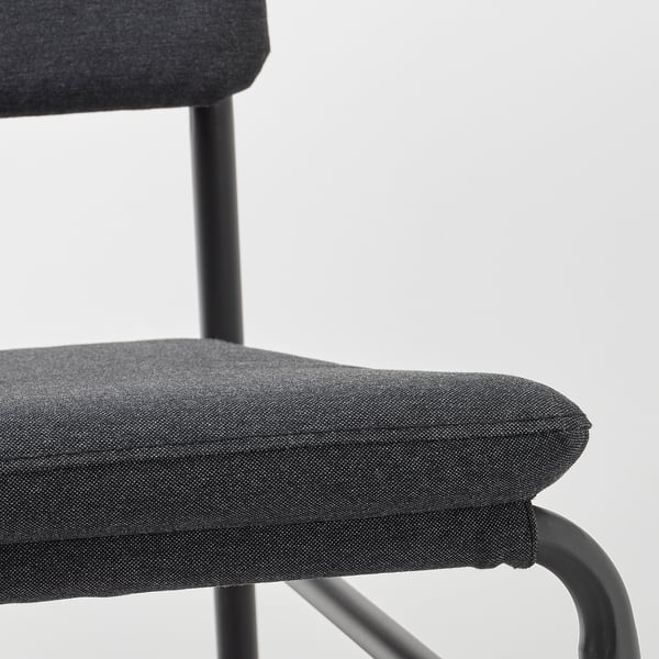 Modern chair in dark grey fabric with sleek metal frame.