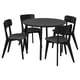 Black round dining table with four matching chairs, sleek design, hardwood materials.