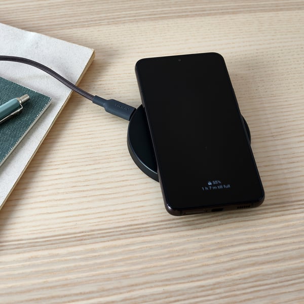 Image description: a smartphone rests on a wireless charging pad, showing 35% charge.
