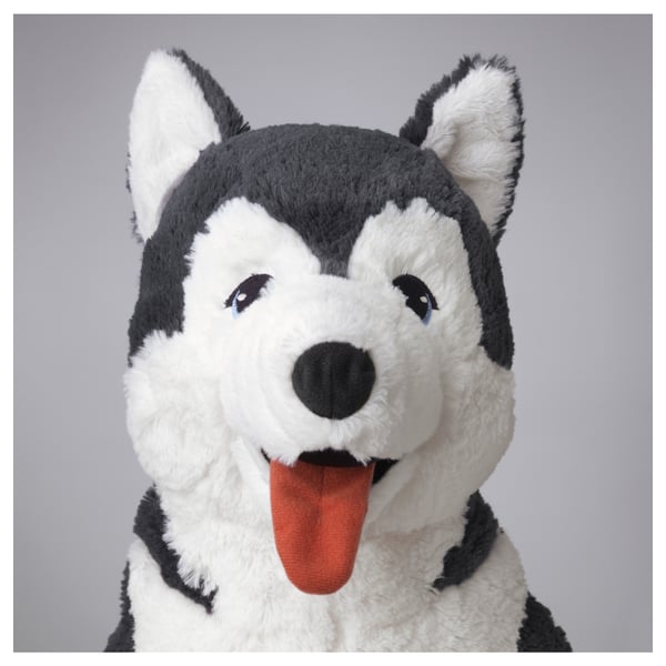 A plush husky toy, soft and huggable with bright blue eyes, white and grey fur, and an orange tongue.