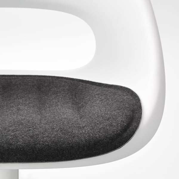Close-up of a modern chairs seat and backrest, smooth black fabric on seat, clean white frame.