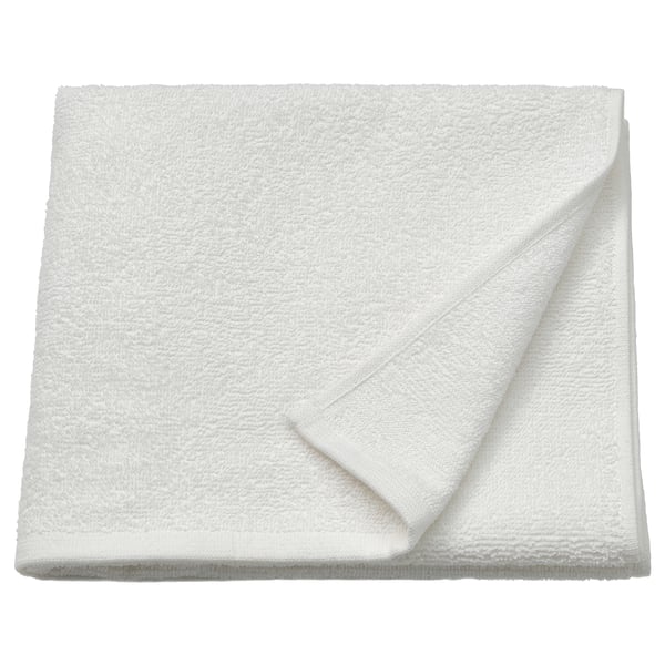 Folded white LUDDVIAL towel of 100% cotton, soft, quick-drying, compact design.