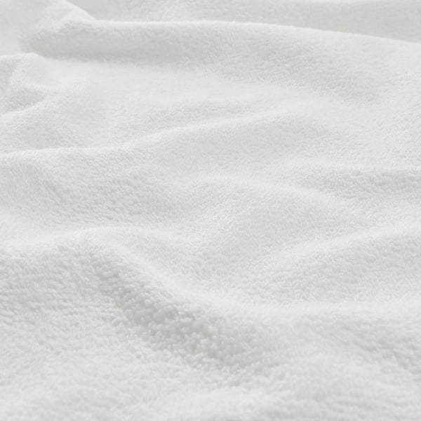 White, soft, folded towel close-up, showcasing smooth, even texture.