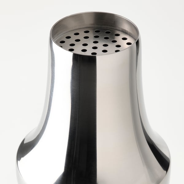 Stainless steel cocktail shaker, polished and durable, with perforated strainer top, perfect for mixing drinks.