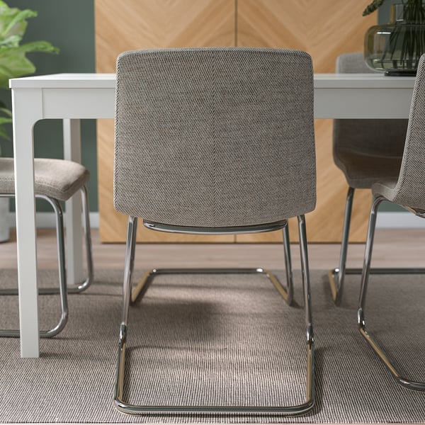 Modern cantilever chair with upholstered back and seat offers comfy, flexible seating. Easy to clean with removable, washable cover.