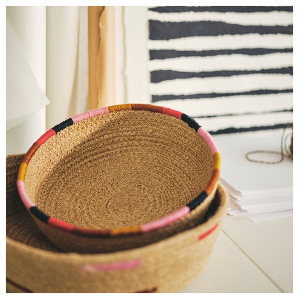 Colourful woven baskets on shelf, perfect for home storage.