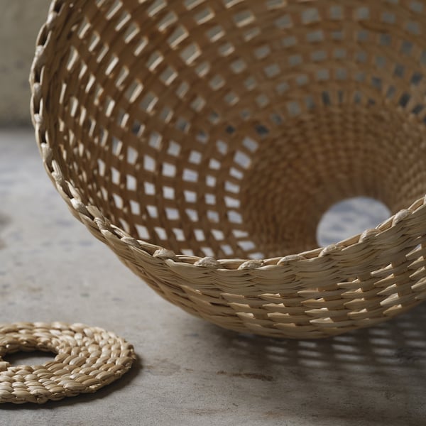 Woven natural fibre basket; tightly braided, sturdy, rustic design.