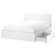 White MALM bed with clean lines, two large under-drawer storage boxes on casters.