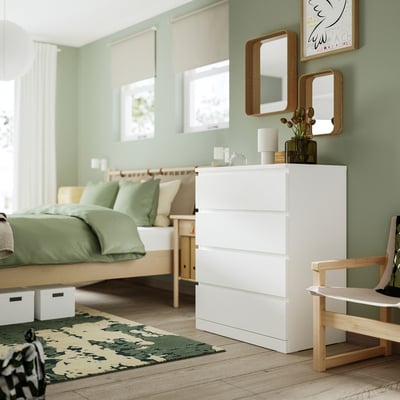 A white MALM chest of drawers. It has four drawers, a smooth surface, and a sleek, rectangular shape. Perfect for bedroom storage.