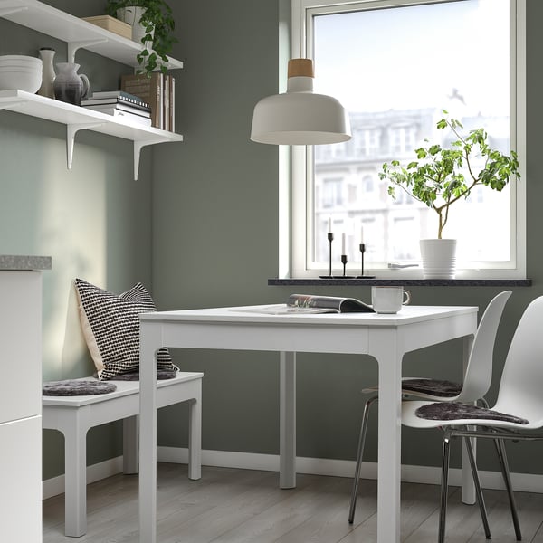 Home office: green walls, white desk, sheep chairs, window.