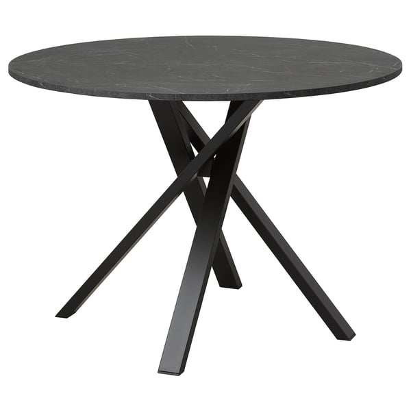 A sleek, black MARIEDAMM dining table with a circular marble top and sturdy, crisscross metal legs.