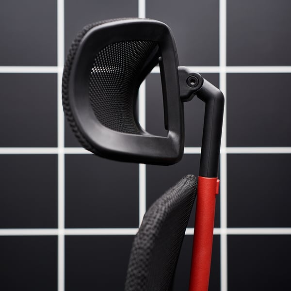 A black and red MATCHSPEL gaming chair with adjustable armrests on a tiled background.