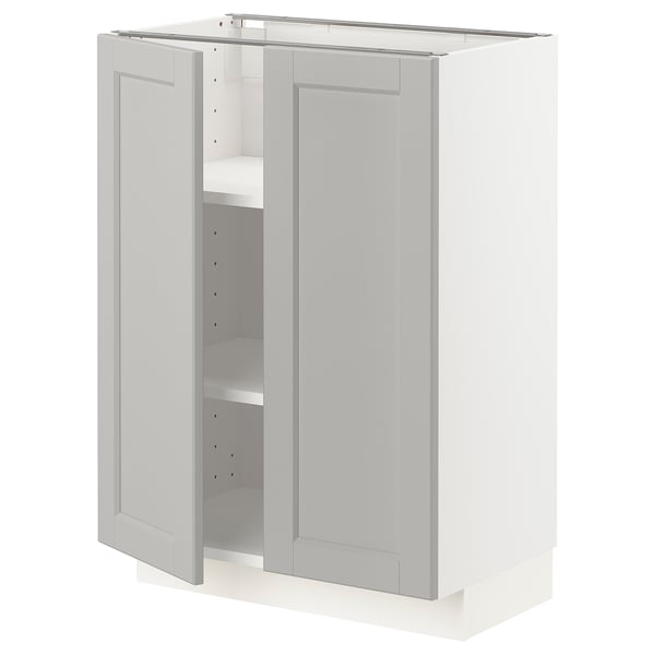 A light grey METOD kitchen cabinet with two doors open, showing shelves inside.