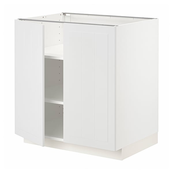 A white METOD kitchen cabinet with one door open, revealing an adjustable shelf inside.