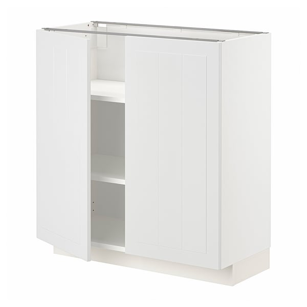 A white METOD kitchen cabinet. It vertical grooves and two open doors revealing adjustable shelves.