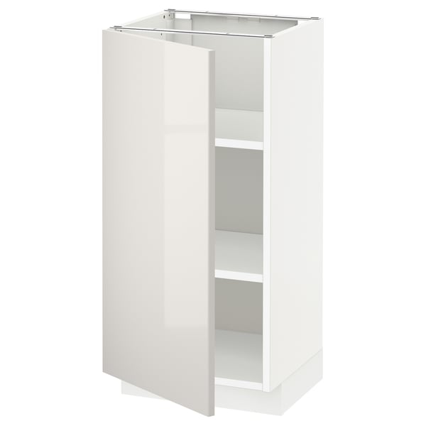 A white METOD kitchen cabinet with a glossy finish and adjustable shelves.