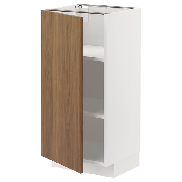 An open METOD kitchen cabinet with a white frame and a single wooden door in a walnut finish.