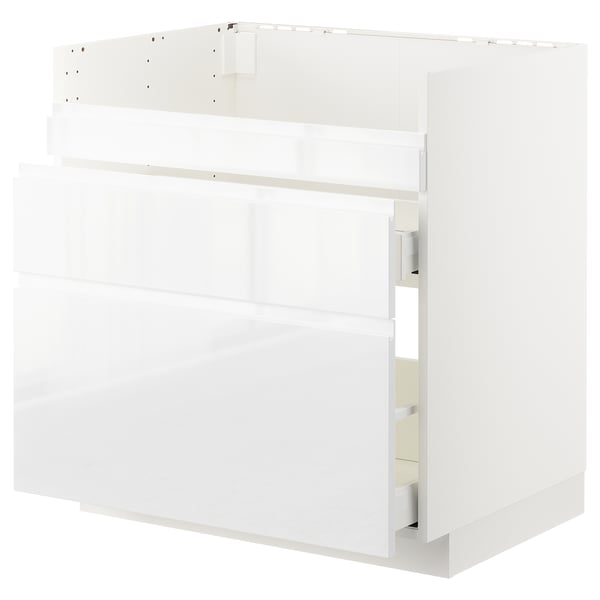 White modern kitchen cabinet, sleek design with multiple drawers and shelves, made of particleboard and metal.