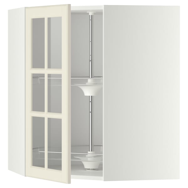 An off-white METOD kitchen cabinet with glass doors and an internal carousel. The cabinet a sturdy frame and adjustable shelves for versatile storage.