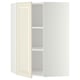 Off-white corner cabinet with one open door, adjustable shelf inside.