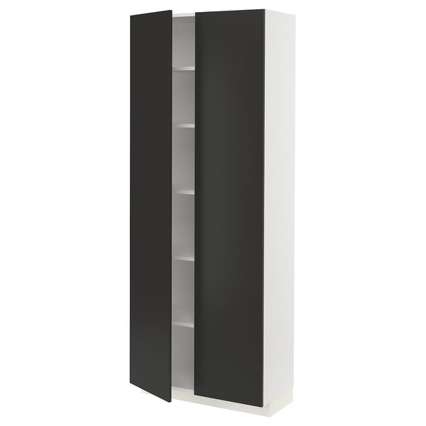 A tall, white ikea METOD kitchen cabinet with black, matte doors. It has four shelves inside, adjustable hinges, and a minimalist design.