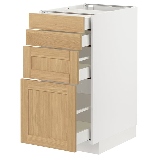This image shows a white METOD kitchen cabinet with four oak veneer drawers, featuring a classic design with beveled edges and a warm wooden feel.
