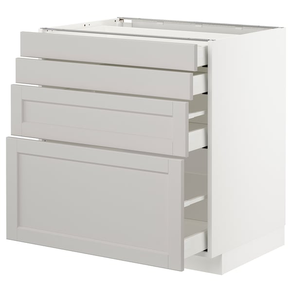 This image shows a white METOD kitchen cabinet with multiple light grey drawers, featuring bevelled edges and self-closing mechanisms.