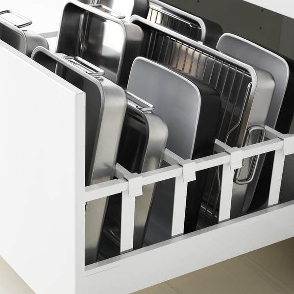 White kitchen drawer organiser with silver metal trays, part of METOD system, holding multiple trays.