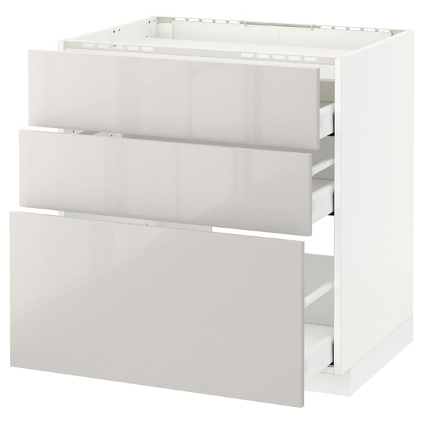 White METOD kitchen cabinet with three grey high-gloss drawers.