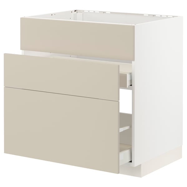 This image displays a beige METOD kitchen cabinet with two drawers, featuring a sleek, modern design.