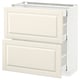 A white METOD kitchen cabinet with off-white bodbyn drawers featuring beveled edges.