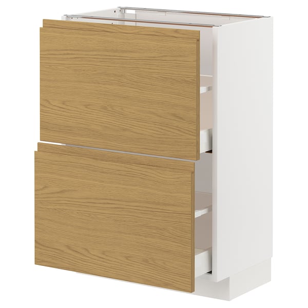 A white METOD kitchen cabinet with oak finish drawers and a minimalist design.