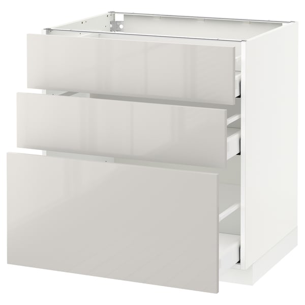 White METOD kitchen cabinet, glossy finish, rectangular shape with three open drawers.