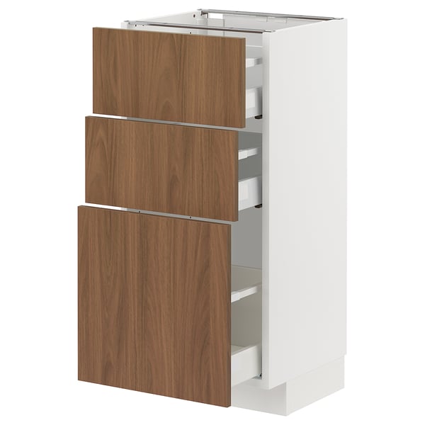A METOD white kitchen cabinet with three wooden drawers.