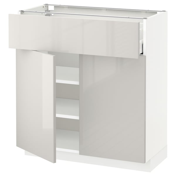 White high-gloss kitchen cabinet with shelves and drawers; sleek modern design.