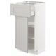 A white METOD kitchen cabinet with a pull-out shelf and a drawer, featuring grey lerhyttan fronts with beveled edges.