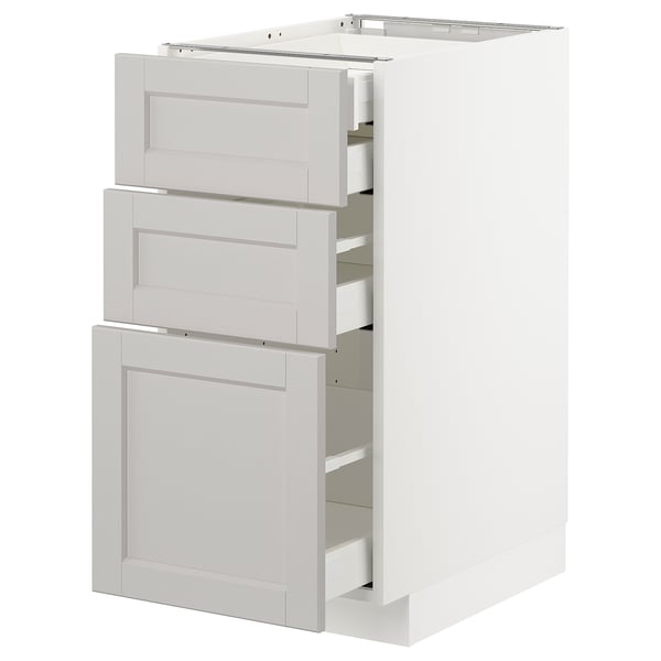 A white METOD kitchen cabinet with three grey drawers and one door, featuring a classic design with bevelled edges.